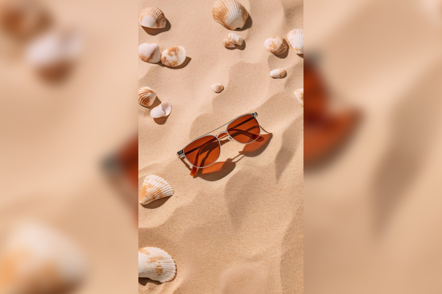 Sunglasses seashells and beach accessories on sandy beach 185